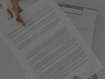 Someone handing paperwork to someone else